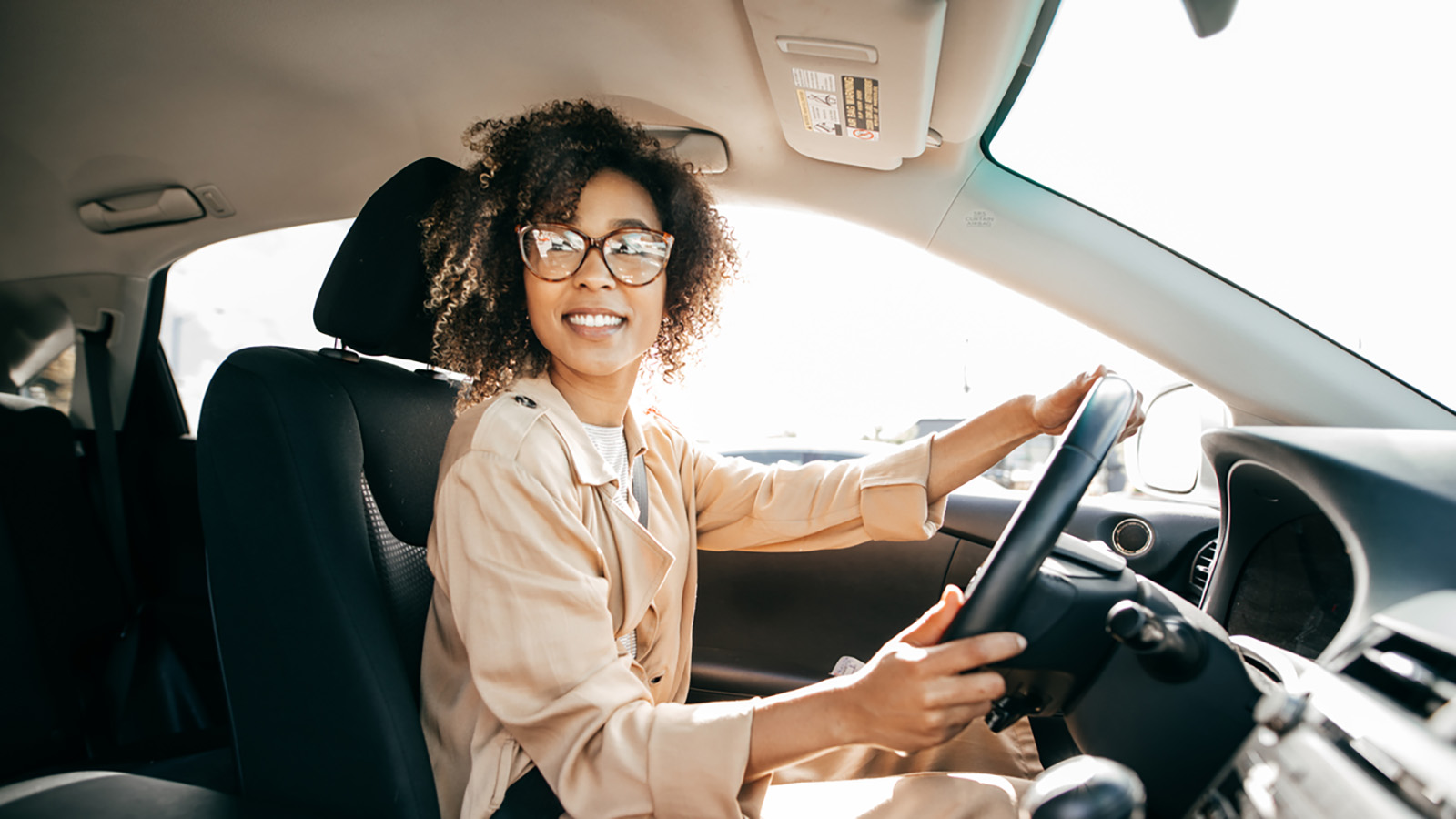 Young woman professional woman driving a car to work